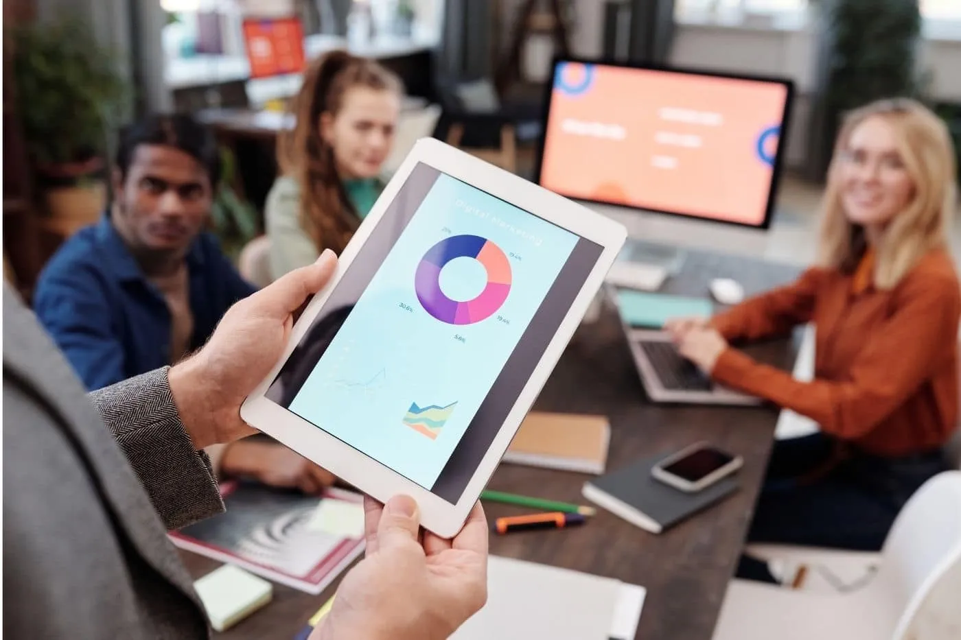Peer Sales Agency holding a tablet with sales enablement materials.