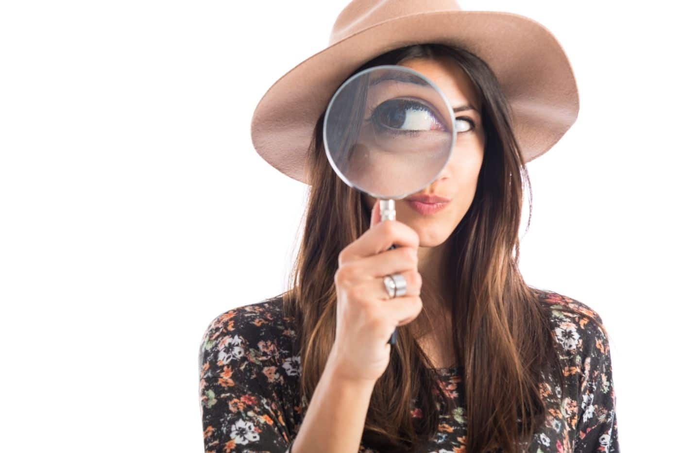 Women holding magnifying glass to signify she knows a lot of about search and SEO.
