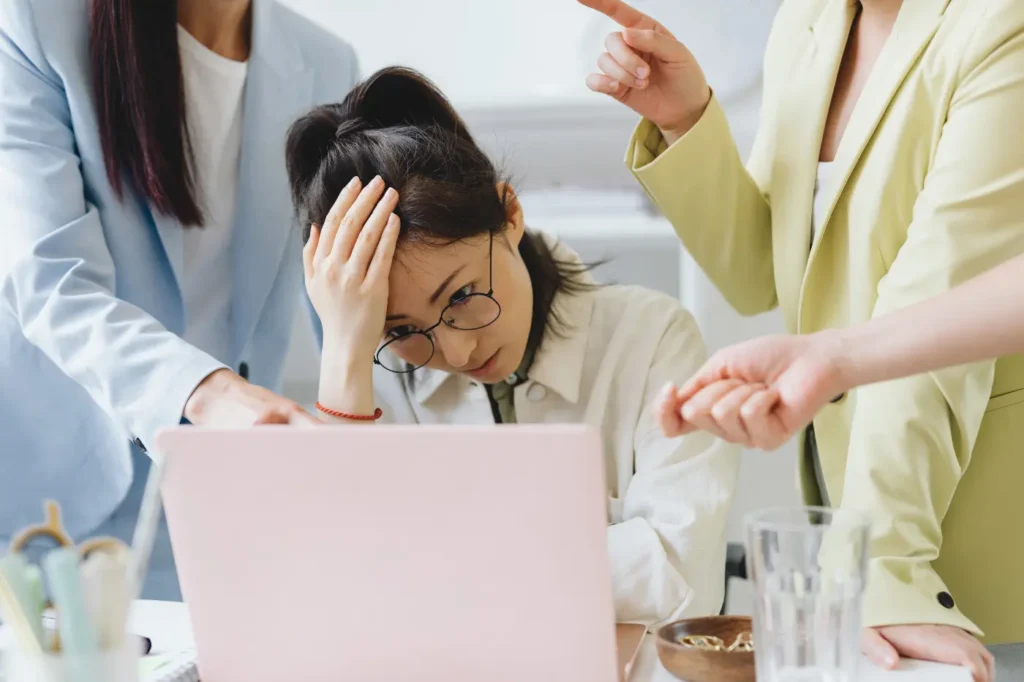 A mid-market sales leader conducts a mid-year revenue review while surrounded by team members offering advice.