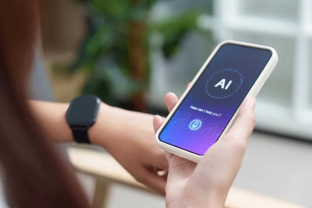 Marketer holding a smartphone displaying an AI voice assistant interface.